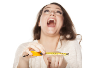 women laughed at the size shown on the measuring tape
