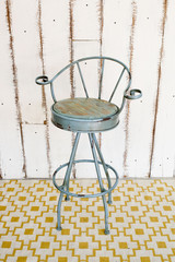 Vintage stool with white wooden background.