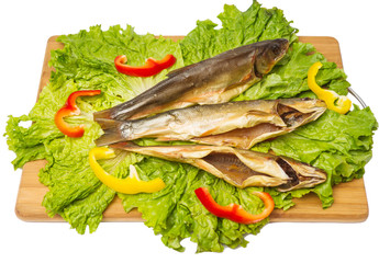 smoked fish with salad and pepper on chopping board