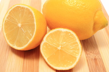 Fresh lemons on wooden background