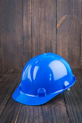 Construction hard hat on wooden background