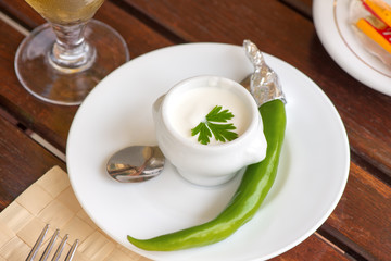 White sauce and green pepper on a plate