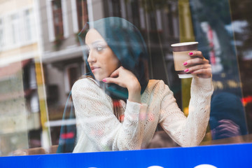 Muslim Woman Behind a Cafe Window