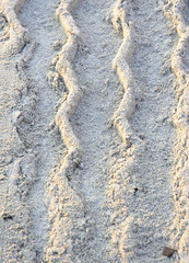 Sand pattern zigzag track in morning light.