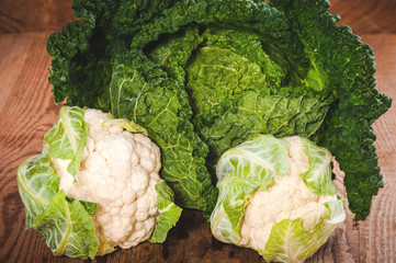 Savoy cabbage and cauliflower on a wooden rustic table