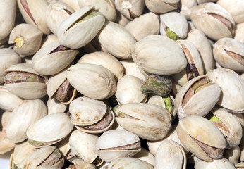 Pistachio nuts closeup filling frame.
