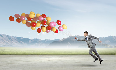 Businessman with balloons