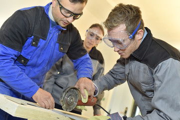 Students learning how to use ceramic saw