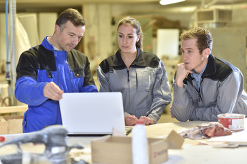 Group of students listening to teacher in workshop
