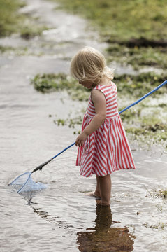 A young girl playing outdoors. 