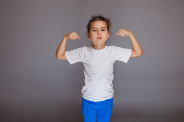 girl hands up sport strength on a gray background