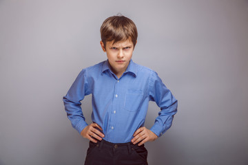 angry teenager boy on  gray background