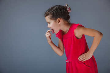 girl put finger her mouth sick in a red dress