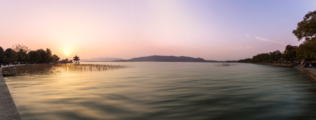 panoramic skyline and lake at sunset in hangzhou,china