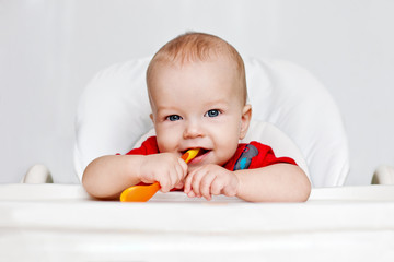 laughing boy holding a spoon