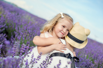 two little girls hugging on a lavender