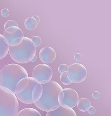 Transparent blue soap bubbles on pink background