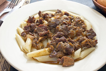 Beef goulash with macaroni in plate