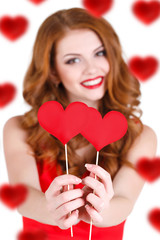 Beautiful girl in a Valentine's Day with a heart on a stick.