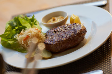 steak with sauce and vegetables