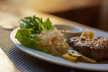 steak with sauce and vegetables