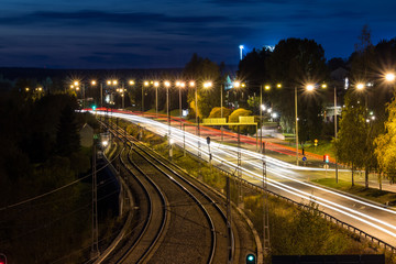 Fototapeta na wymiar Road at Night by Rails