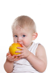 Fototapeta na wymiar A child eats an apple