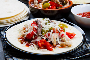 Beef and chicken  Fajitas with colorful bell peppers in  tortill