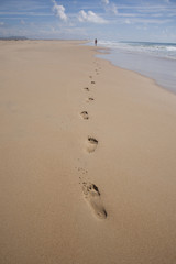 far woman walking at beach