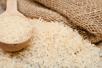 rice from the bag and wooden spoon