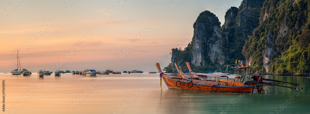 Wall mural sunset with colorful sky and boat on the beach