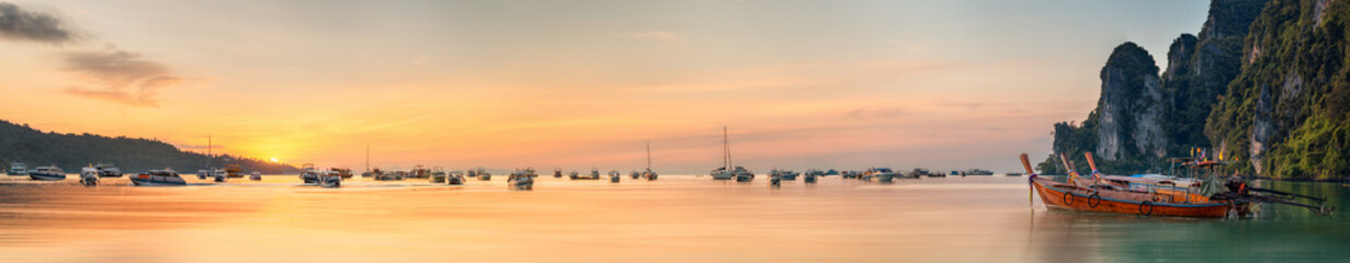 sunset with colorful sky and boat on the beach