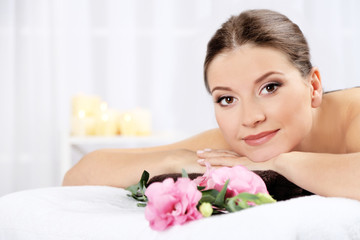 Fototapeta na wymiar Beautiful young woman having relax in spa salon