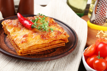 Portion of tasty lasagna on table