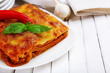 Portion of tasty lasagna on table