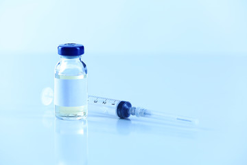 Vaccine in vial with syringe