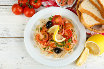 Tasty pasta with shrimps, black olives and tomato sauce