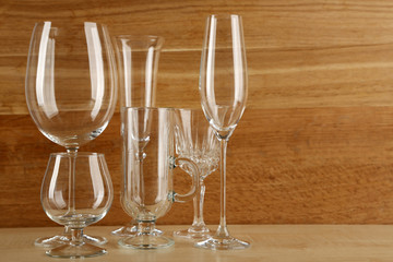 Empty goblets on wooden background