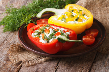 Fresh peppers filled with curd and dill close-up horizontal