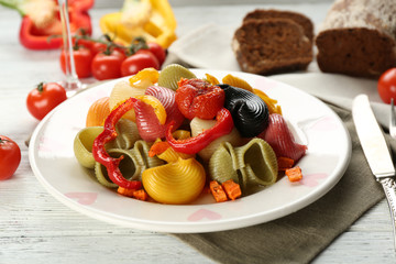 Tasty multicolor pasta with pepper, carrot and tomatoes