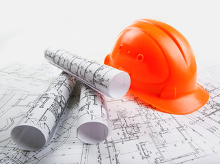 Architectural blueprint rols and helmet