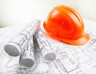 Architectural blueprint rols and helmet