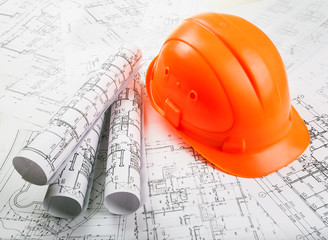 Architectural blueprint rols and helmet