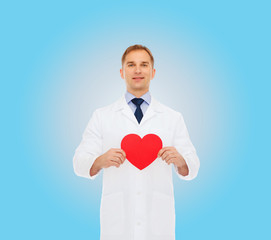 smiling male doctor with red heart