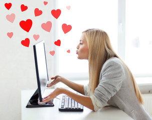 woman sending kisses with computer monitor