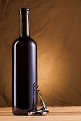 wine bottle and corkscrew on table