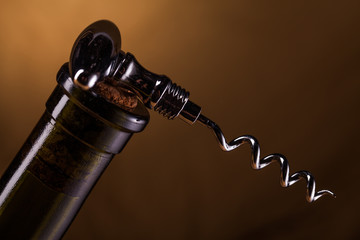 wine bottle and corkscrew on table