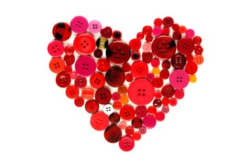 Heart shape of red and pink buttons over white
