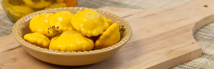 Pickled Pattypan Squash on white background. Selective focus.