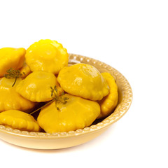 Pickled Pattypan Squash on white background. Selective focus.